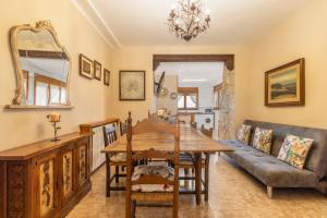 a dining room with a table and a couch at Casa Rural Cal Pallol in Camarasa