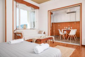 a living room with two beds and a table at SeaView City in Samos