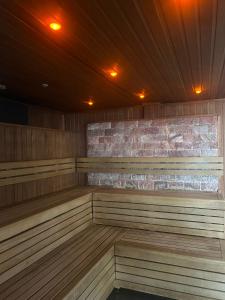 a empty sauna with a brick wall and lights at Beech Hill Hotel & Spa in Windermere