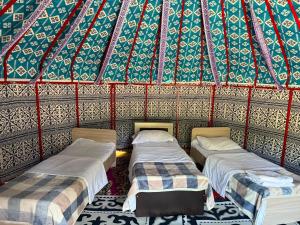 a room with three beds in a yurt at Kausar in Kalīnīno