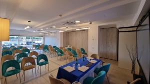 a conference room with a blue table and chairs at Versilia Palace Hotel in Marina di Pietrasanta +111 photos