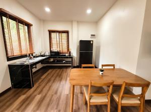 a kitchen and dining room with a wooden table at Soul House - Stay Beautifully in Ko Kong Nui +2 photos