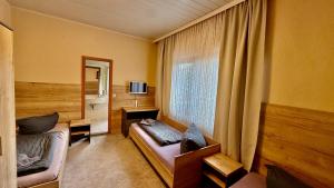 Телевизор и/или развлекательный центр в Hotel Pension Pamina
