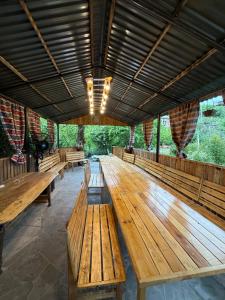 a large room with wooden tables and benches at Aygut Garden in Aygut