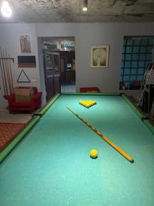 a pool table with a ball and cues on it at Aygut Garden in Aygut