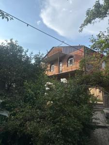 a building with a balcony and trees in front of it at Aygut Garden in Aygut +3 photos