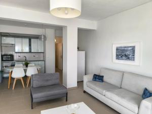 a living room with a couch and a table at OLIVE & SEA in Nea Moudania