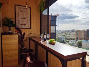 a bar with wine glasses and a view of a city at Ulaanbaatar Heritage Stay in Ulaanbaatar