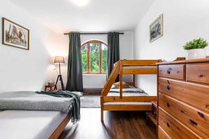 a bedroom with a bunk bed and a staircase at Resort Biskupský Dvůr in Višňová