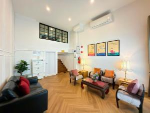 a living room with two couches and a table at Sleep Walker Poshtel in Chiang Mai