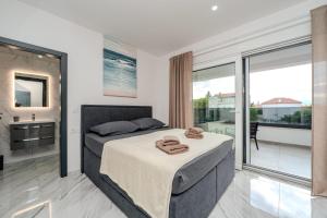 a bedroom with a bed with towels on it at Villa Lukas in Nin +49 photos
