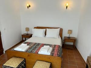 a bedroom with a bed with two night stands at Casa Grande do Monte in Mértola