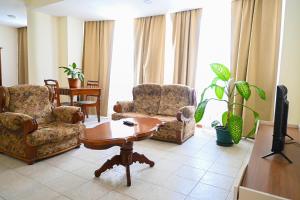 a living room with two chairs and a table at Hotel Rocha in Ribeira Grande