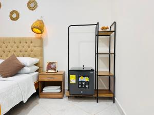 a bedroom with a bed and a book shelf next to a bed at HOTEL HERMOSO CARIBE in Tolú