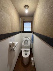 a small bathroom with a toilet and a window at Guest House Hana in Otsu +67 photos