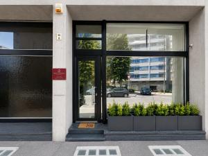 a door of a building with plants in front at Maison Sicilienne in Turin