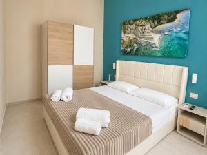 a bedroom with a bed with two towels on it at Maison Sicilienne in Turin