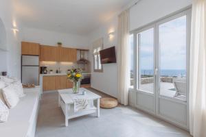 a kitchen and living room with a view of the ocean at Bonatsa House in Agios Georgios