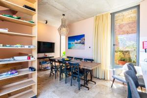 a dining room with a table and chairs at Room in Historic Knights House at the Marina in Senglea