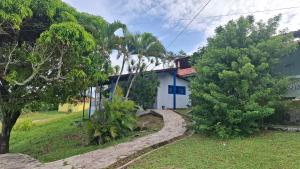a house with a tree in front of it at Chalet da Bela Vista in Itamaracá
