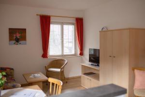 a small room with a desk and a window at Haus Bernhard in Schenna