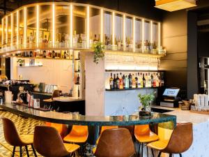 a bar with chairs and a counter in a restaurant at TRIBE Riga City Centre - Renovated 2026 in Riga