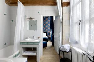 a bathroom with a sink and a mirror at Maison D'hôtes Saint-Gildas in Beaufort-en-Vallée +61 photos