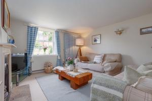 a living room with a couch and a coffee table at Westport Cottage in Wareham