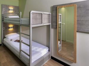 a bunk room with two bunk beds and a mirror at ibis Budget Cognac in Châteaubernard +105 photos