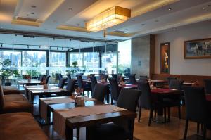 a restaurant with tables and chairs and windows at Volley Hotel Istanbul in Istanbul