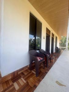 a hallway with benches and windows on a building at Bikash Homestay in Mangpu