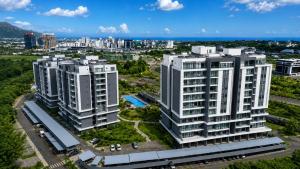 an aerial view of two white buildings in a city at Minissy Suites in Moka