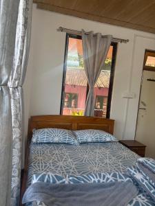 a bedroom with a bed and a window at Bikash Homestay in Mangpu
