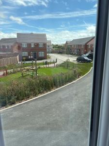 a view from a bus window of a road with houses at StaywithusHighbridge in Highbridge