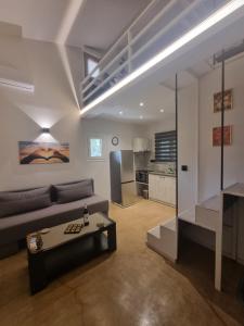a living room with a couch and a table at SmallHouseLefkada ΘΕΜΑ in Lefkada
