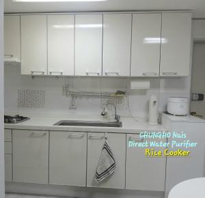 a white kitchen with a sink and white cabinets at K Hubhouse - Taereung stn 5min walk#villa 4pax in Seoul +20 photos