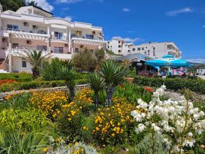a garden with flowers in front of a building at Adriatic Apartment in Ulcinj