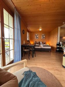 a living room with a couch and a bed and a table at CapoBnB, Montainview, Terrace in Aeschi bei Spiez