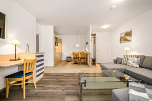 a living room with a couch and a table at Leuchtturm an der Seebrücke in Zingst