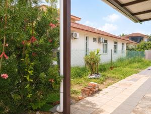 a view of a house from the porch at Family Retreat w Kid Pool, BBQ Games Sleeps 10pax Melaka in Kampong Beringin