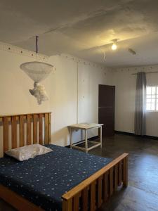 a bedroom with a bed and a table in it at Belalonte House, Iringa in Iringa