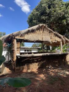 a small hut with a thatched roof at Belalonte House, Iringa in Iringa