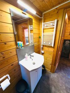 a bathroom with a sink in a wooden cabin at Perła in Stegna +189 photos
