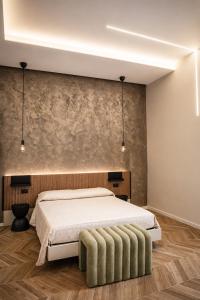 a bedroom with a large bed and a stone wall at Donna Teresa Amalficoast in Cetara