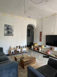 a living room with a couch and a table at Belalonte House, Iringa in Iringa