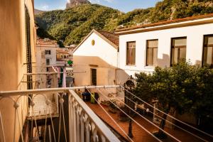 a balcony of a building with mountains in the background at Donna Teresa Amalficoast in Cetara