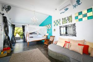 a living room with a couch and a bed at Villa Lorizon in Rodrigues Island +53 photos