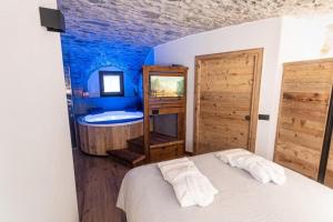 a bedroom with a bed with two towels on it at Giuly's Home Luxury in Bormio