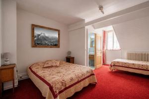 a hotel room with a bed and a window at Hôtel du Centre in Villard-de-Lans