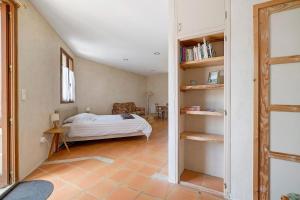 a bedroom with a bed and a book shelf at Studio au Pied de Puycelsi in Puycelci